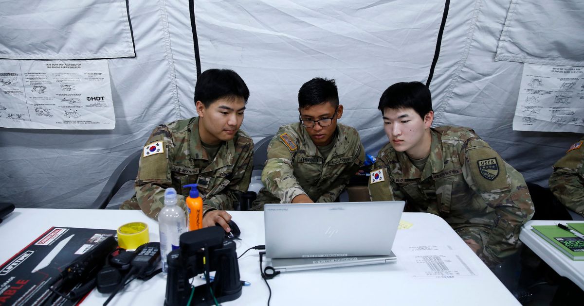Personnel from the South Korean Navy's 5th Mine/Amphibious Flotilla and US Army's 29th Harbormaster Detachment from Hawaii discuss an operation during a joint South Korean-US military CDEx (Combined Distribution Exercise) at the Combined Command Post in Dogu Coast, Pohang, on June 13, 2023.