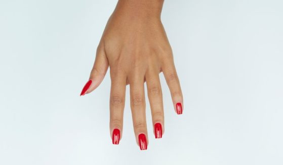 A woman's manicured hand is seen in this stock image.