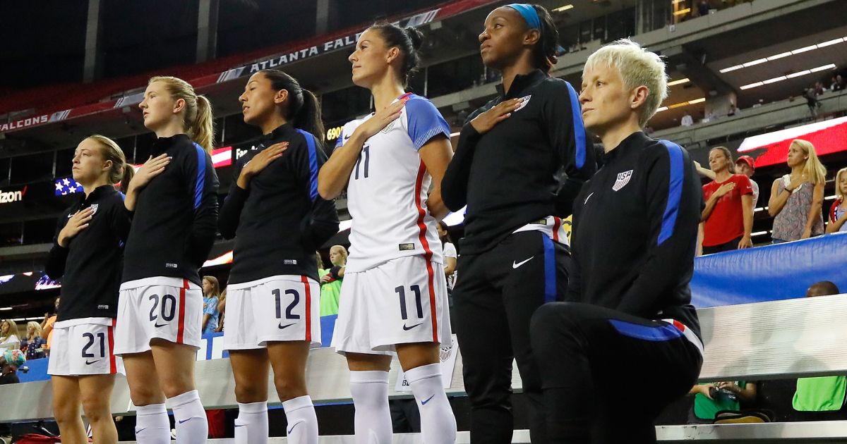 Megan Rapinoe #15 kneels during the National Anthem prior to the match between the United States and the Netherlands at Georgia Dome on September 18, 2016 in Atlanta, Georgia.