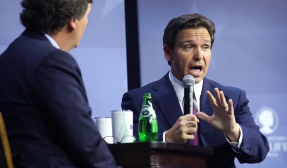 Florida Gov. Ron DeSantis is interviewed by former Fox News host Tucker Carlson Friday at the Family Leadership Summit in Des Moines, Iowa.