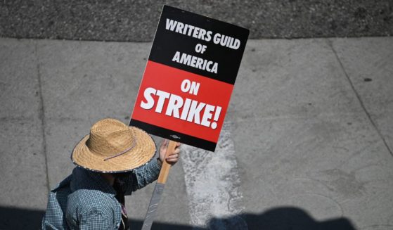 Hollywood writers and their supporters walk the picket line outside Universal Studios Hollywood in Los Angeles on June 30.