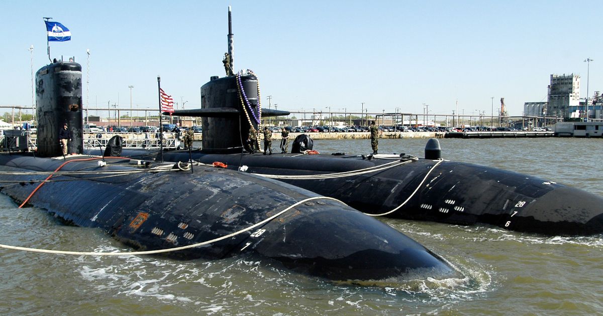The USS Newport News, right, secures itself next to its sister Los Angeles-class submarine USS Boise after returning to Norfolk Naval Station in Norfolk, Virginia, on April 23, 2003.