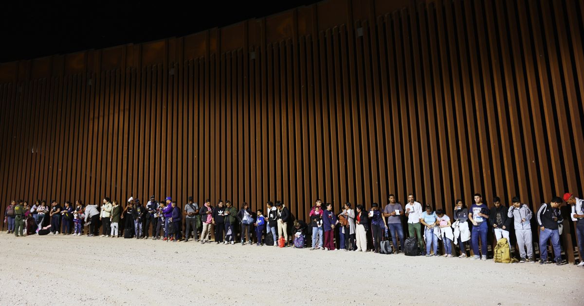 Immigrants seeking asylum, who were apprehended at the time Title 42 expired, are processed by U.S. Border Patrol agents, after crossing into Arizona from Mexico, on May 11, 2023 in Yuma, Arizona.