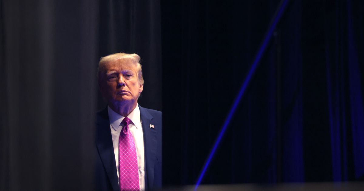 Former U.S. President Donald Trump waits to be introduced at the Oakland County Republican Party's Lincoln Day dinner at Suburban Collection Showplace on June 25, 2023 in Novi, Michigan.