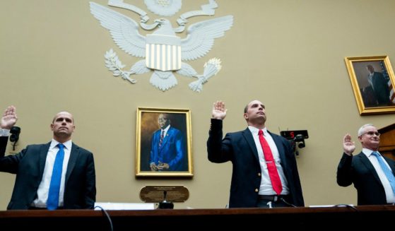 Ryan Graves, Americans for Safe Aerospace Executive Director, from left, U.S. Air Force (Ret.) Maj. David Grusch, and U.S. Navy (Ret.) Cmdr. David Fravor, are sworn in during a House Oversight and Accountability subcommittee hearing on UFOs, Wednesday on Capitol Hill in Washington.