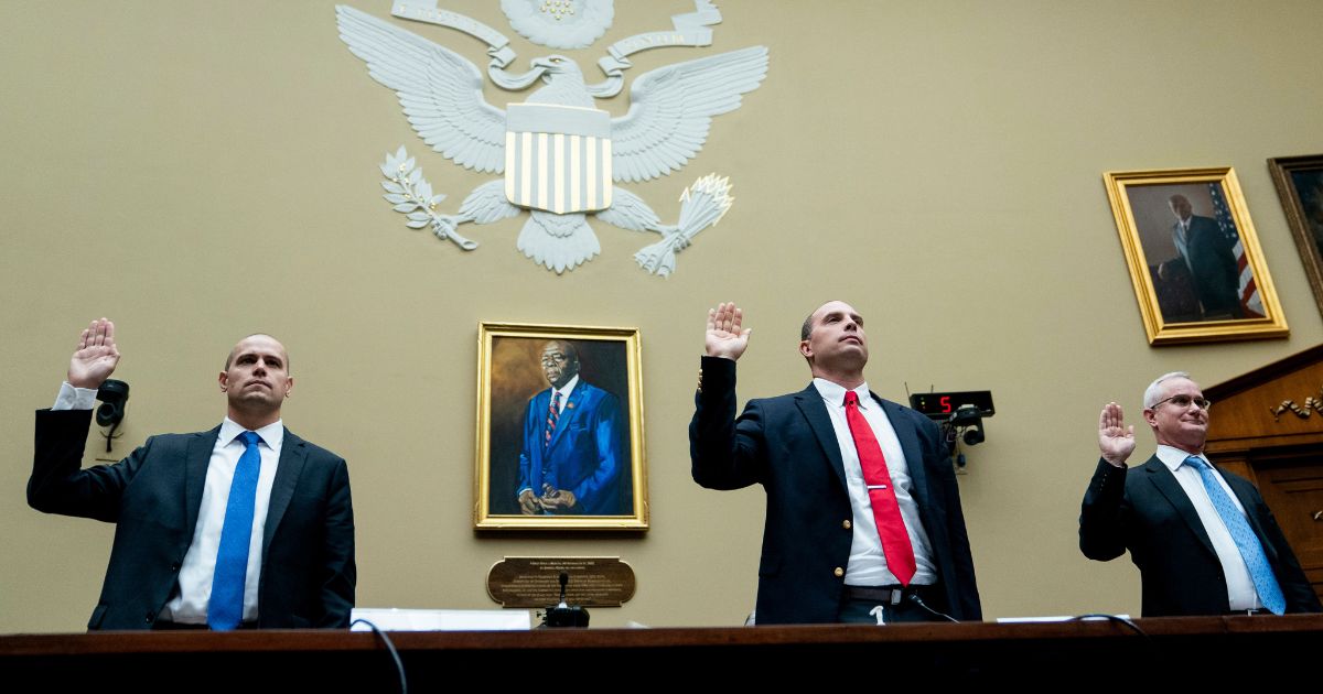 Ryan Graves, Americans for Safe Aerospace Executive Director, from left, U.S. Air Force (Ret.) Maj. David Grusch, and U.S. Navy (Ret.) Cmdr. David Fravor, are sworn in during a House Oversight and Accountability subcommittee hearing on UFOs, Wednesday on Capitol Hill in Washington.