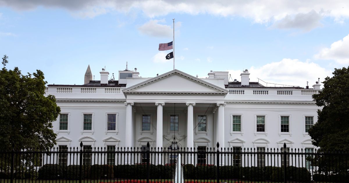 The American flag on top of the White House is lowered to half staff in memory of Queen Elizabeth II on Sept. 8, 2022, in Washington, D.C.