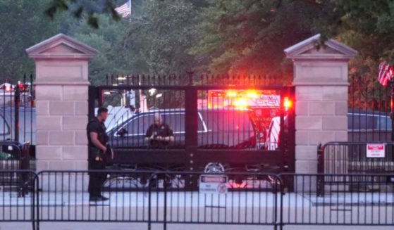 HAZMAT crews are pictured behind the gates on West Executive outside the entrance to the West Wing in Washington D.C., on Sunday.