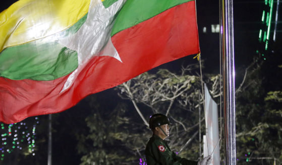 A Myanmar military soldier hoists a national flag during a ceremony to mark the 69th anniversary of Independence Day in Yangon, Myanmar on Jan. 4, 2017. A Swiss citizen was arrested in military-ruled Myanmar for writing a screenplay and creating a film that allegedly insulted Buddhism, state media reported Saturday, Aug. 19, 2023.