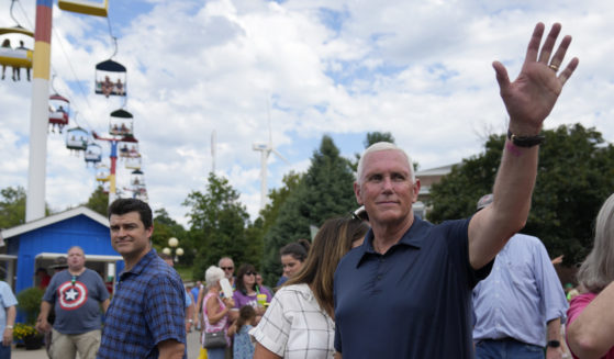 Republican presidential candidate former Vice President Mike Pence waves as he tours the grounds at the Iowa State Fair, Friday, Aug. 11, 2023, in Des Moines, Iowa.