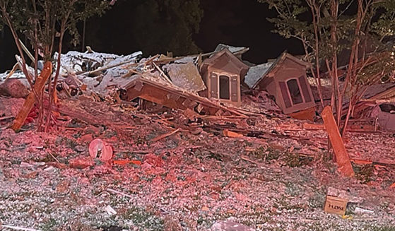 This photo taken early Tuesday morning in Mooresville, North Carolina, shows the rubble of a home that collapsed. Iredell County Emergency Management said in a Tuesday news release that emergency officials responded to the home after a reported explosion and collapse and that one person was injured and another person was found dead in the debris.