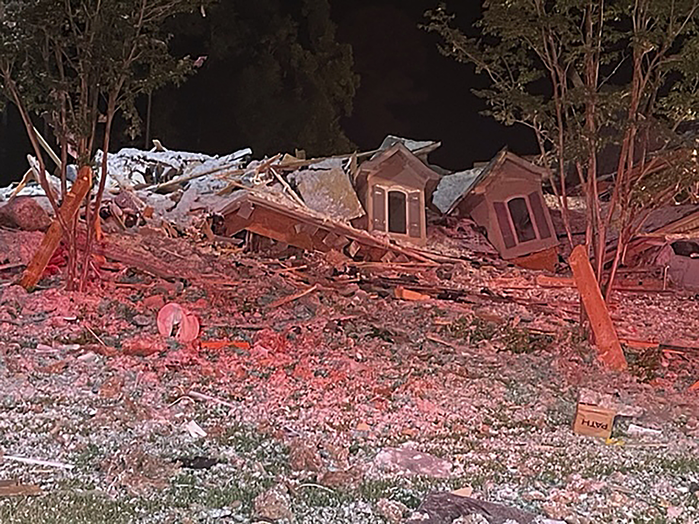 This photo taken early Tuesday morning in Mooresville, North Carolina, shows the rubble of a home that collapsed. Iredell County Emergency Management said in a Tuesday news release that emergency officials responded to the home after a reported explosion and collapse and that one person was injured and another person was found dead in the debris.