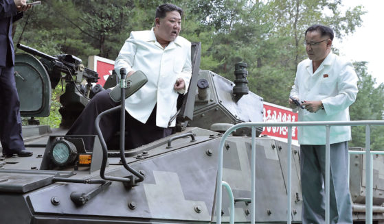 In this undated photo provided on Monday by the North Korean government, North Korean leader Kim Jong Un, center, rides on an armored vehicle during his visit to a military factory in North Korea last week. Independent journalists were not given access to cover the event depicted in this image, and its contents cannot be independently verified.