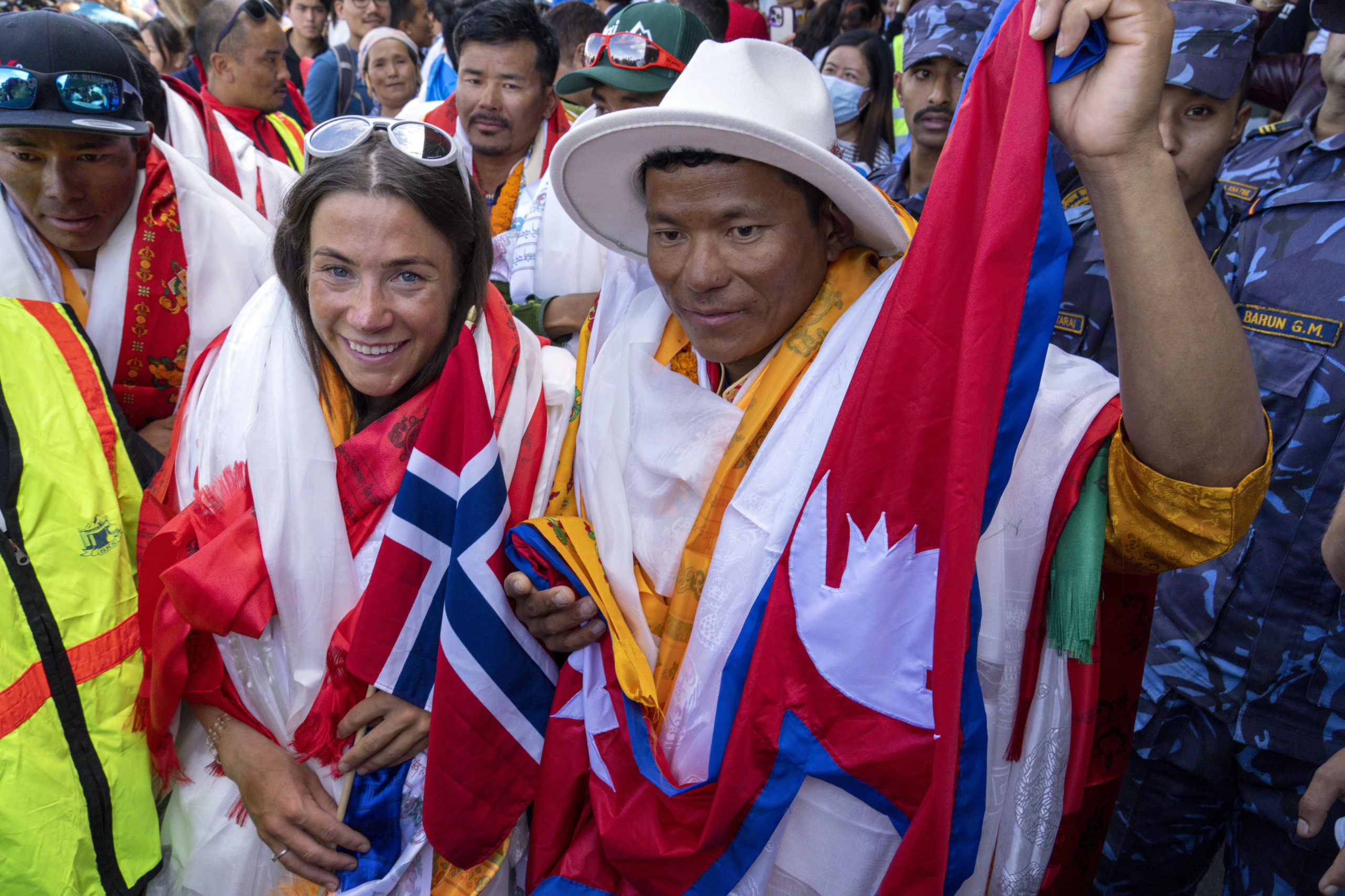 Norwegian climber Kristin Harila, left, and her Nepali sherpa guide Tenjin Sherpa, right, who climbed the world’s 14 tallest mountains in record time, arrive in Kathmandu, Nepal, on Aug. 5.