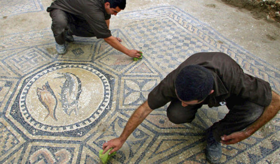 Prisoners work on a nearly 1,800-year-old decorated floor from an early Christian prayer hall discovered by Israeli archaeologists in the Megiddo prison on on Nov. 6, 2005.