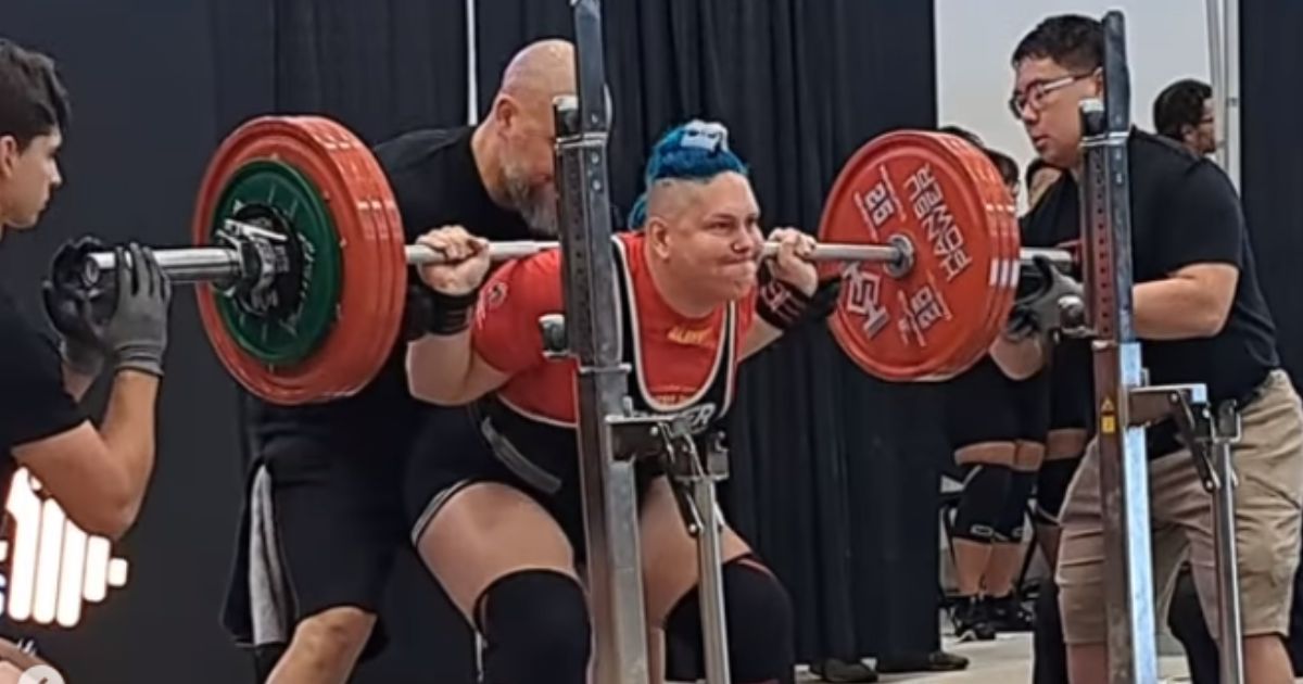 Anne Andres performs a squat in a powerlifting competition in Canada.