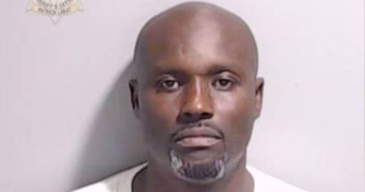 Volunteer high school football coach Carl Sledge, who coached for Benjamin E. Mays High School in Atlanta, was arrested and charged with battery after video shows him yelling at a player and allegedly punching him during a game on Saturday.