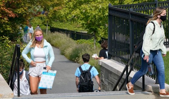 Students wear masks at the Boston College campus in Boston during the coronavirus pandemic on Sept. 17, 2020.