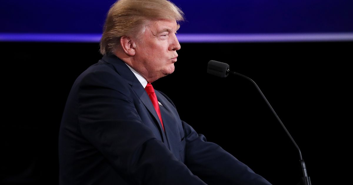 Donald Trump listens to Hillary Clinton speak during a U.S. presidential debate on Oct. 19, 2016, in Las Vegas.