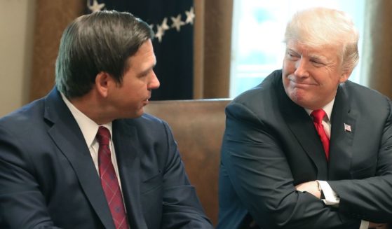 Florida's Ron DeSantis sits next to then-President Donald Trump during a meeting with governors-elect in the Cabinet Room of the White House in Washington on Dec. 13, 2018.