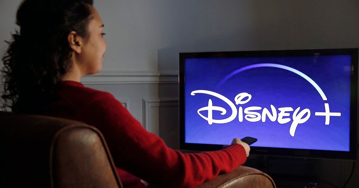 The Disney+ logo is displayed on a TV.