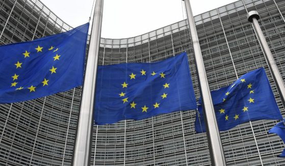 European Union flags fly at half-mast at the EU headquarters in Brussels on Sept. 9, 2022.