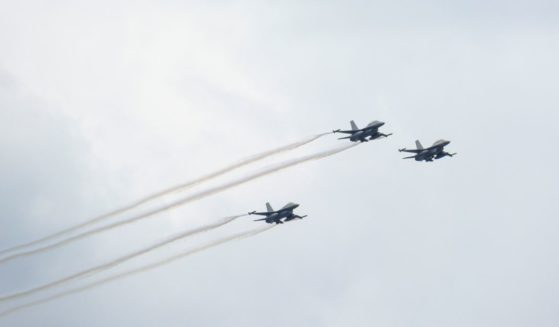 Three General Dynamics F-16 Fighting Falcons fly for a final training flight before the July 21 parade in Brussels, Belgium, on July 19.