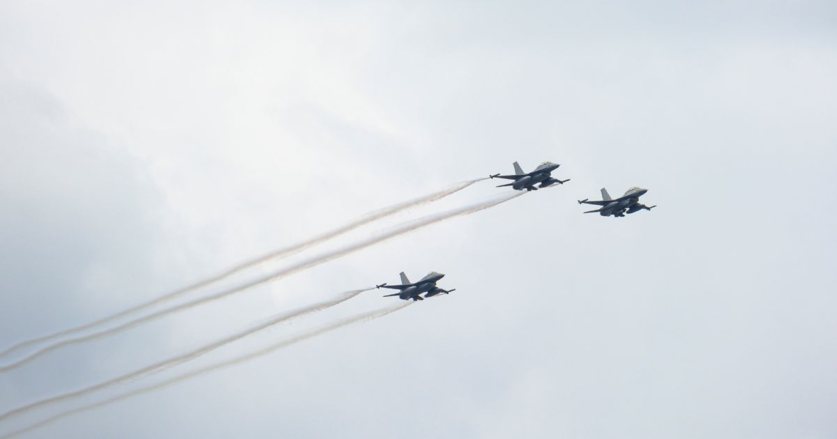 Three General Dynamics F-16 Fighting Falcons fly for a final training flight before the July 21 parade in Brussels, Belgium, on July 19.