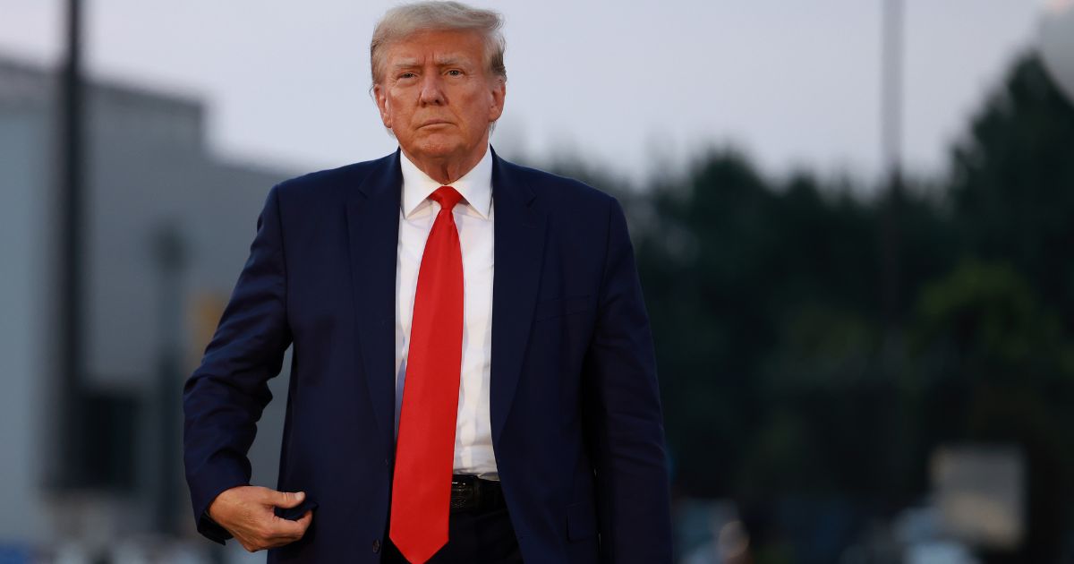 Former U.S. President Donald Trump arrives to depart at Atlanta Hartsfield-Jackson International Airport after being booked at the Fulton County jail on August 24, 2023 in Atlanta, Georgia. Trump was booked on multiple charges related to an alleged plan to overturn the results of the 2020 presidential election in Georgia.