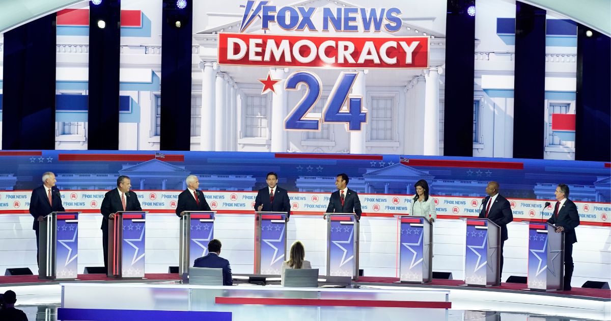 The other candidates on stage listen as Florida Gov. Ron DeSantis, center, speaks during the Republican presidential primary debate hosted by Fox News in Milwaukee on Wednesday.