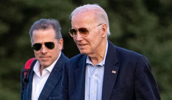 President Joe Biden, right, walks his son Hunter Biden, left, from Marine One June 25 as they return from Camp David.