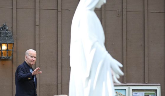 President Joe Biden waves as he leaves Our Lady of Tahoe Catholic Church in Zephyr Cove, Nevada, on Saturday.