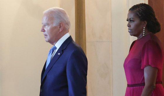 President Joe Biden arrives with former first lady Michelle Obama for a ceremony to unveil the Obamas' official White House portraits at the White House in Washington on Sept. 7, 2022.