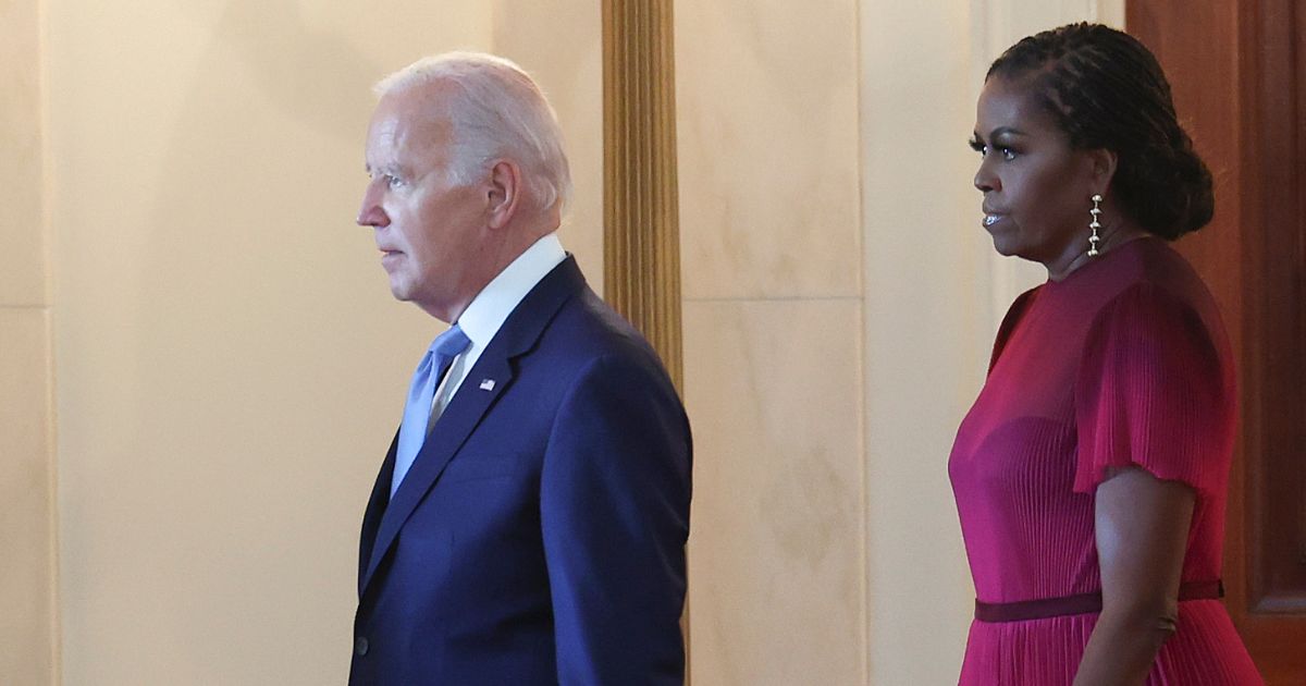 President Joe Biden arrives with former first lady Michelle Obama for a ceremony to unveil the Obamas' official White House portraits at the White House in Washington on Sept. 7, 2022.