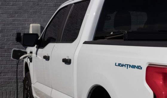 A stock photo from October 2022 shows a Ford F-150 Lightning pickup at a charging station.