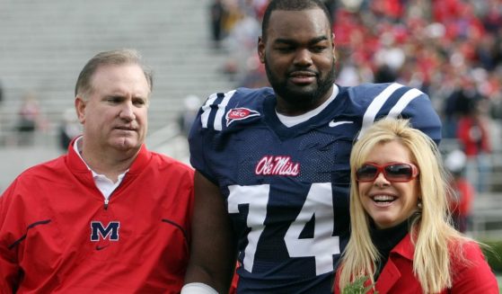 Michael Oher of the Ole Miss Rebels stands with his family prior to a game against the Mississippi State Bulldogs at Vaught-Hemingway Stadium on Nov. 28, 2008, in Oxford, Mississippi.
