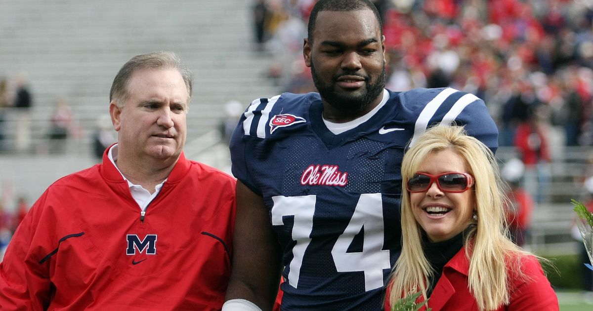 Michael Oher of the Ole Miss Rebels stands with his family prior to a game against the Mississippi State Bulldogs at Vaught-Hemingway Stadium on Nov. 28, 2008, in Oxford, Mississippi.