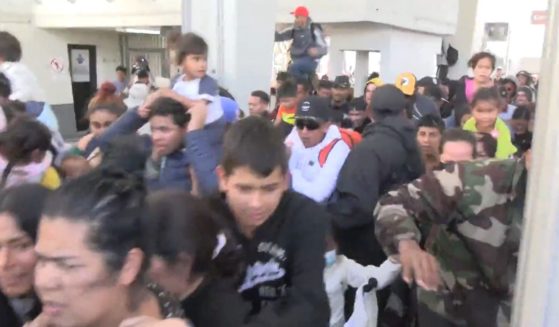 Migrants storm the border to try to get into Texas.