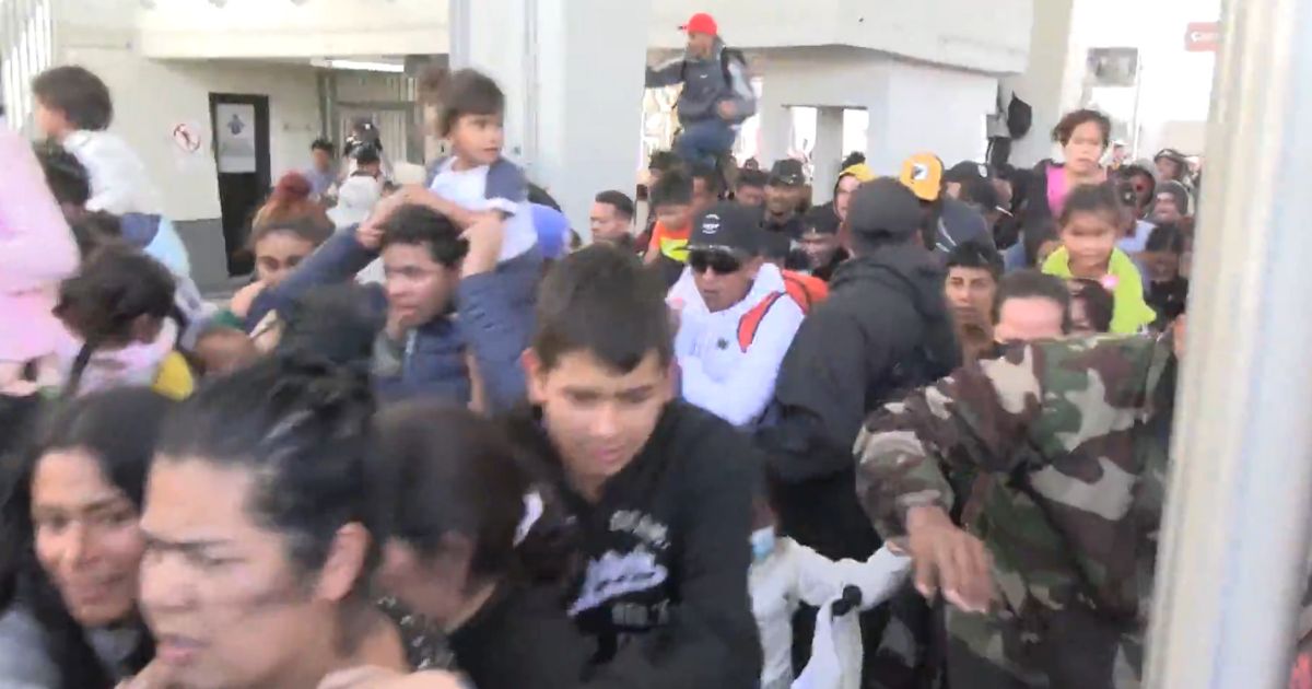 Border Patrol responds to mass migrant border crossing with riot control measures.