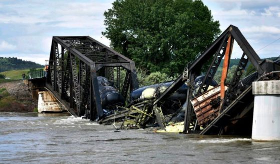 train cars immersed in the Yellowstone River after a bridge collapse