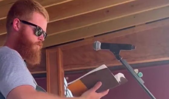 Viral country music sensation Oliver Anthony took the time to open his free concert on Sunday by reading from the Bible.