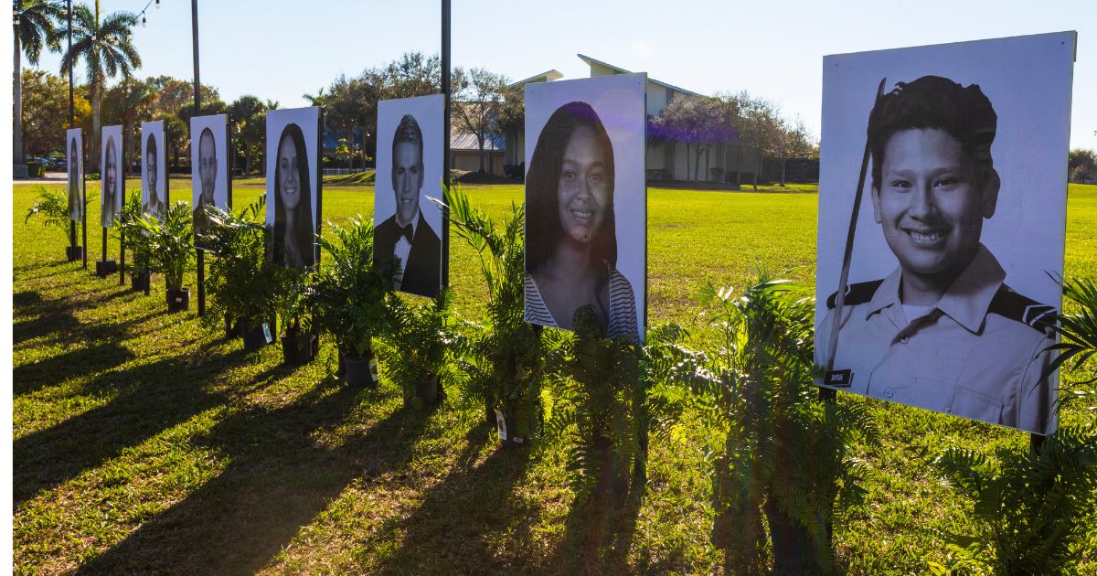 Photos of the 17 people killed during the 2018 Marjory Stoneman Douglas High School mass shooting are displayed in Parkland, Florida. Ballistics experts re-enacted the shooting Friday to gather evidence in a lawsuit against the sheriff's deputy who was at the scene but failed to confront the shooter.