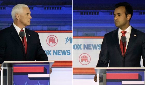 During Wednesday's Republican primary debate, former Vice President Mike Pence, left, was booed by the audience after he attacked Vivek Ramaswamy, right.