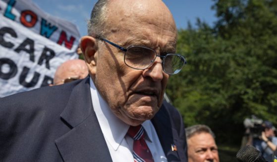 Rudy Giuliani speaks to members of the media after being booked at the Fulton County Jail in Atlanta on Aug. 23.