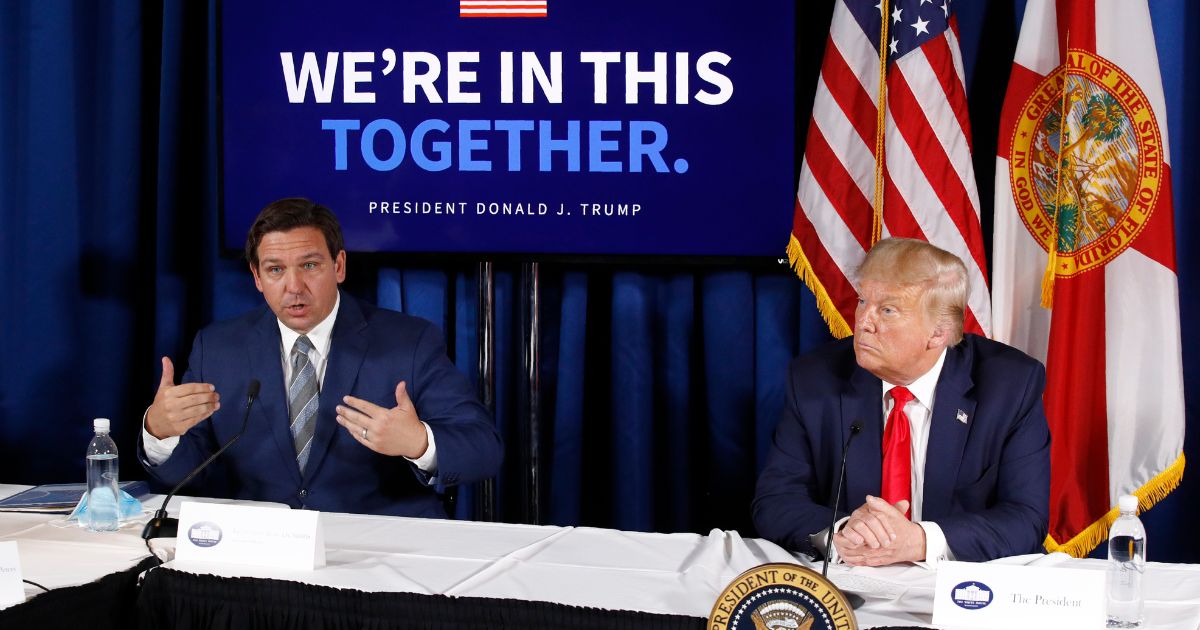 Florida Gov. Ron DeSantis, left, speaks alongside President Donald Trump during a roundtable discussion on the coronavirus outbreak and storm preparedness at Pelican Golf Club in Belleair, Florida, on July 31, 2020.