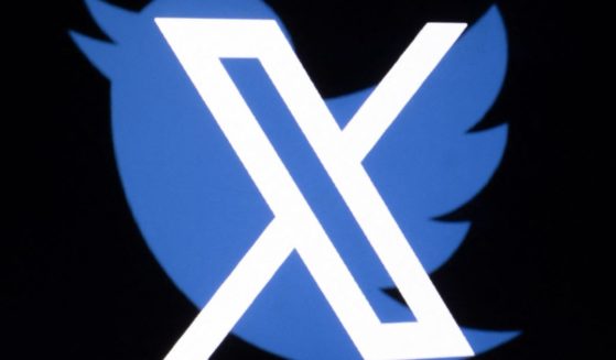 This illustration photo shows the new X logo superimposed over the old Twitter logo.