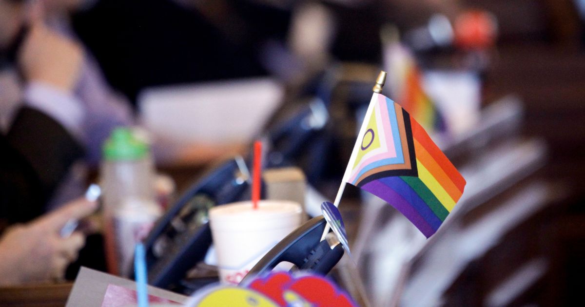 A flag supporting LGBT rights decorates a desk on the Democratic side of the Kansas House of Representatives during a debate March 28 in Topeka. In Oregon, a hospital patient allegedly was denied cancer treatment earlier this summer because of comments she made about transgenderism.