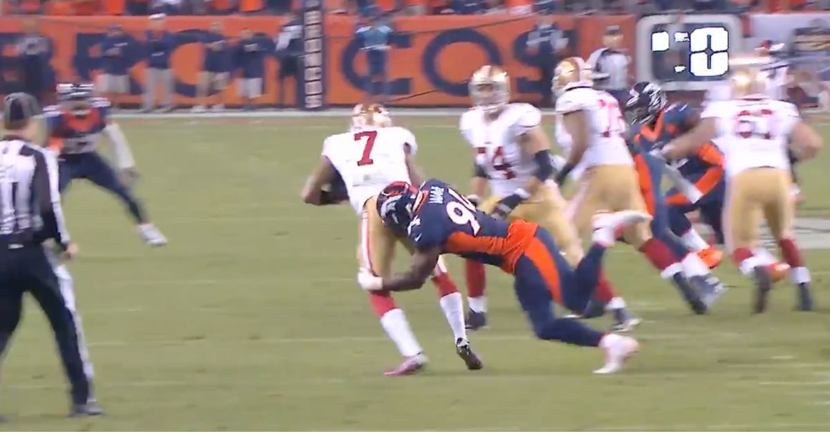 In a post, Demarcus Ware, right in navy blue, is seen after pulling off a “fake spin” on an offensive lineman in order to sack 49ers QB Colin Kaepernick, number 7 in white.