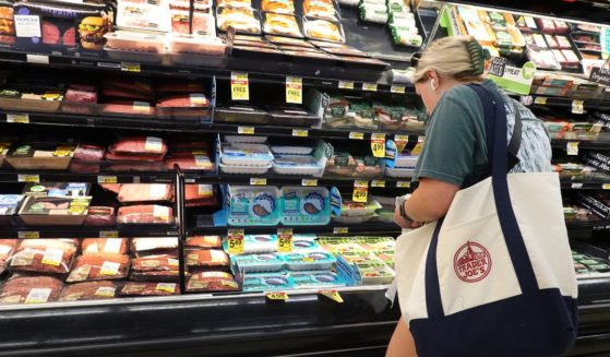 A woman shops for meat at a supermarket in Chicago on Wednesday.