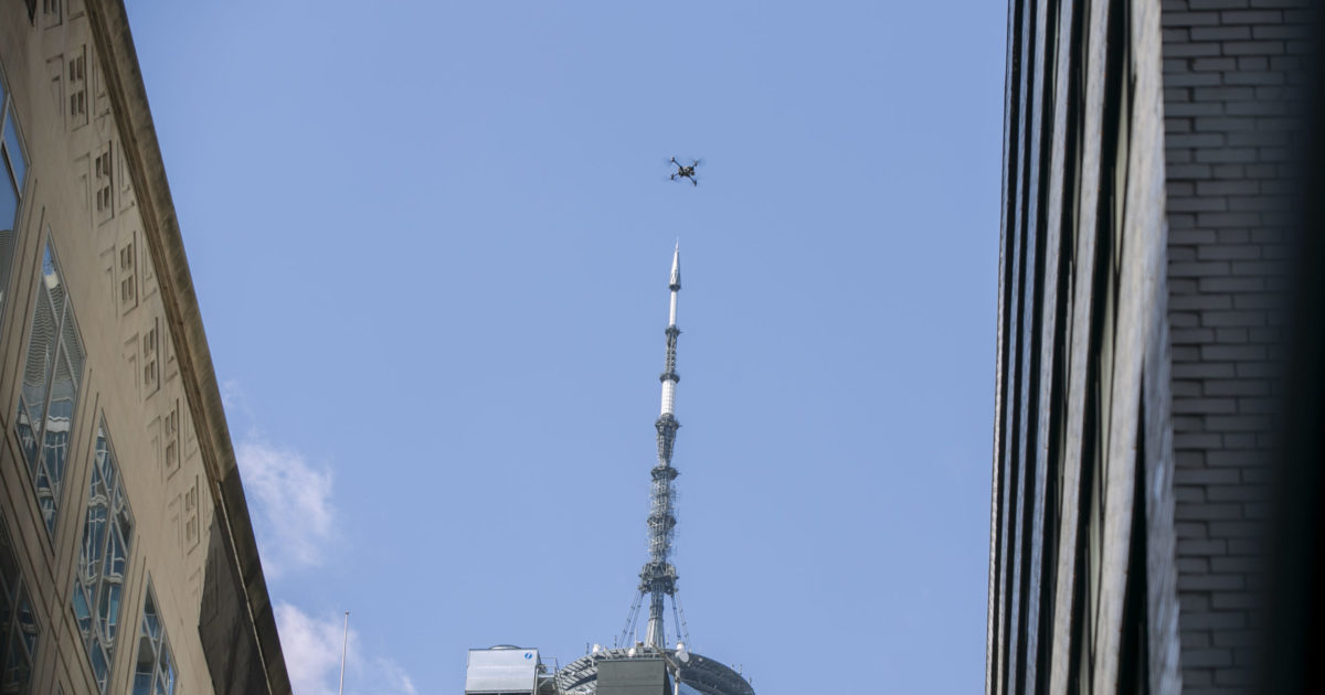 a drone flies over the site of a partially collapsed parking garage